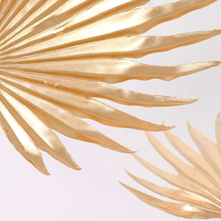 Gold palm leaf decor accents for home styling.