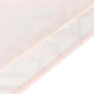 Soft pink fabric with a smooth texture and subtle sheen.