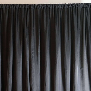 Black curtain draping with soft texture and sheen.