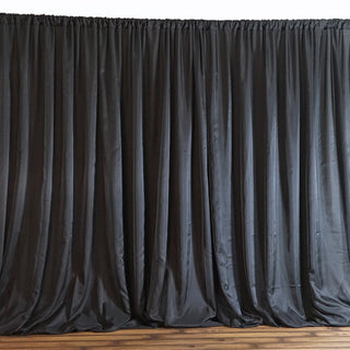 Black satin curtain draped elegantly, adding a touch of sophistication to any space.