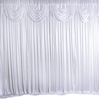 White draped fabric backdrop for events and photography.