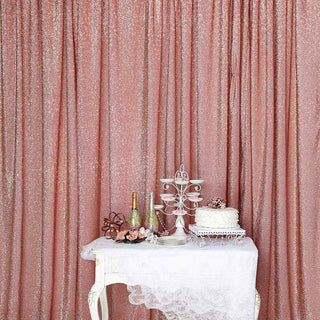 Elegant pink sequin backdrop with decorative table and cake display.