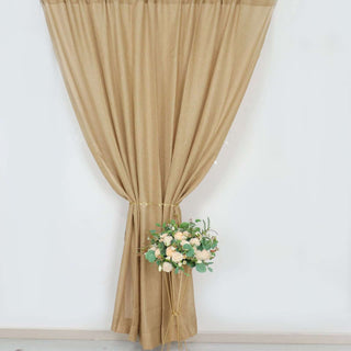 Beige curtain draped elegantly with a floral arrangement in a modern pot.