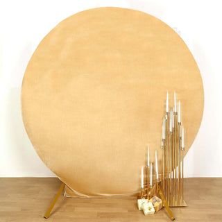 Round beige backdrop with gold candle holders and candles
