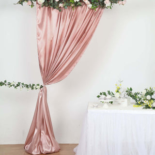 Elegant blush pink satin drapery with floral accents for event decor