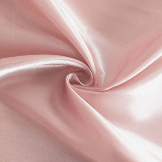 Soft pink satin fabric with a smooth, shiny texture.