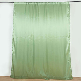 Green satin curtain draped on a rod against a plain backdrop