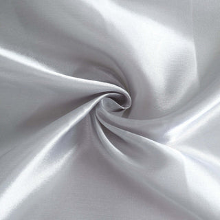 Silky silver fabric close-up showing smooth texture and shine.