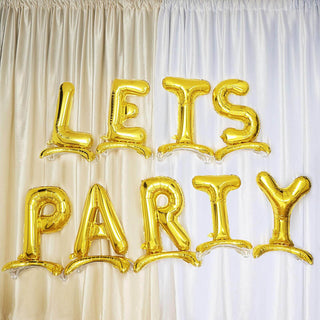 Gold "LET'S PARTY" balloons against a curtain backdrop.