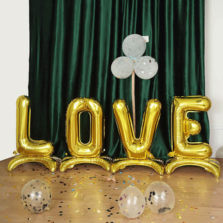 Gold "LOVE" balloon letters with confetti and balloons on a festive backdrop.
