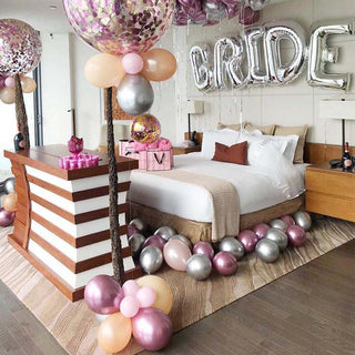 Stylish bridal suite decorated with balloons and a festive sign.