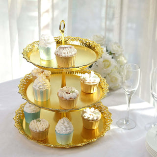 Gold three-tier cupcake stand with assorted decorated cupcakes.