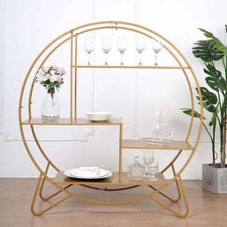 Circular gold shelving unit with glassware and decorative items.