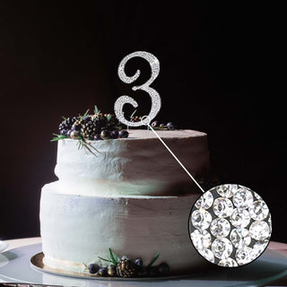 Glittering number 3 cake topper on a decorated cake.