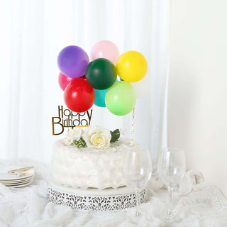 Birthday cake with colorful balloons and a "Happy Birthday" topper.