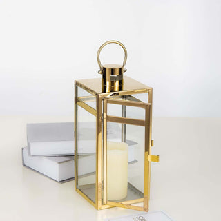 Gold lantern with glass panels and candle, elegant home decor accent.