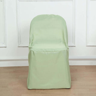 Green chair cover on a simple chair in a minimalist setting.
