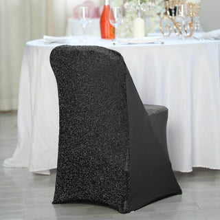 Elegant black chair cover with sparkly texture for event decor.