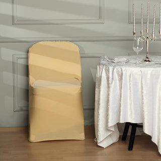 Yellow chair cover draped over a chair beside a dining table.
