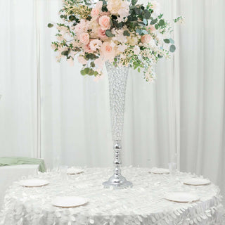 Elegant floral centerpiece in a tall vase for event decoration.