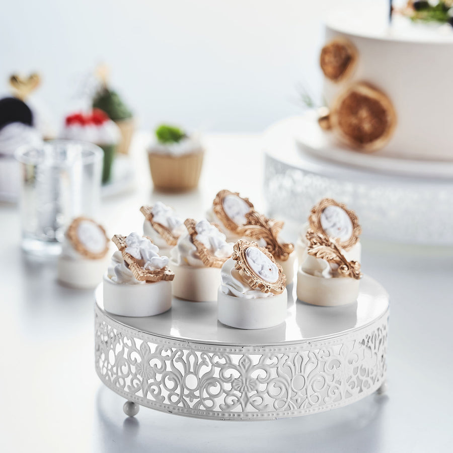 Elegant dessert cakes with ornate designs on a decorative stand.