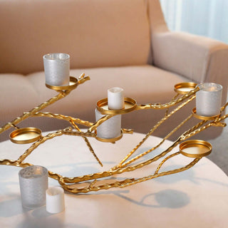 Elegant gold candle holder with glass votives for modern decor.