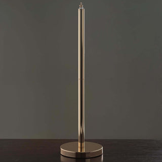 Gold pen holder on a dark surface, sleek and elegant design.