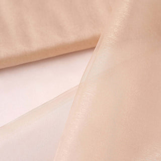 Peachy sheer fabric with a soft sheen for elegant drapery.
