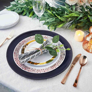 Elegant dinner table setting with decorative plates and cutlery.