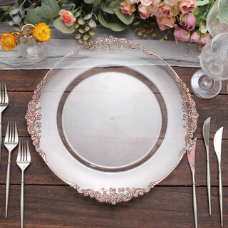 Elegant clear plate with rose gold detailing, surrounded by cutlery and floral decor.