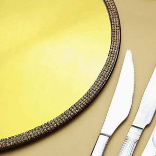 Elegant gold serving platter with crystal accents and silver cutlery.