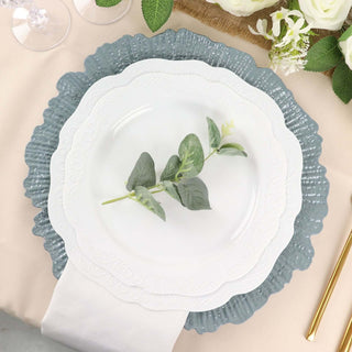 Elegant white plate with decorative green rim, styled with eucalyptus sprig.