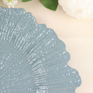 Blue scalloped ceramic plate on a soft beige surface.