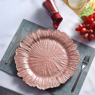 Decorative pink textured plate on a table setting with utensils and garnishes.