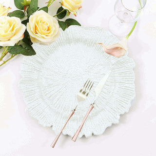 Elegant textured white plate with fork and knife, surrounded by roses.
