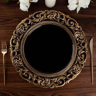 Elegant gold ornate charger plate on a wooden table with cutlery.