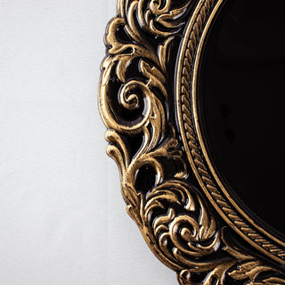 Ornate gold mirror frame detail on a plain background.