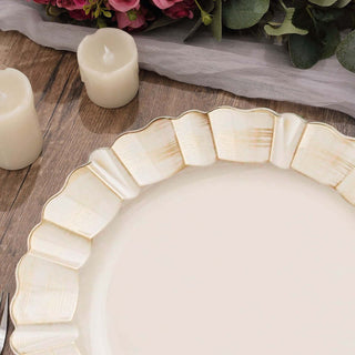 Elegant scalloped edge plate on a rustic wooden table with candles and flowers.