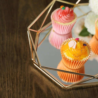 Colorful cupcakes on a reflective tray with a geometric design.