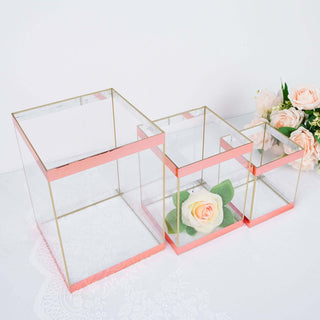 Set of three glass storage boxes with rose gold accents and floral arrangement