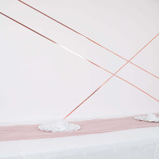 Decorative table setting with pink runner and white plates on a minimalist backdrop.