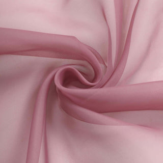 Pink sheer fabric swirling in elegant folds.