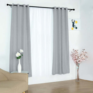Gray curtain panels hanging in a bright room with decorative elements.
