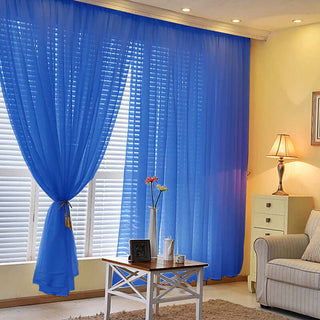 Blue sheer curtains elegantly draping a window in a cozy living room setting.