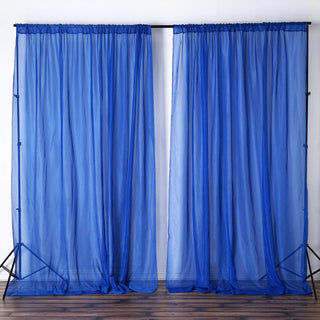 Blue sheer curtains on a backdrop stand, creating a light and airy atmosphere.