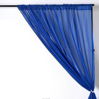 Sheer blue curtain draped elegantly on a curtain rod.
