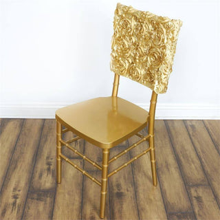 Gold decorative chair with rose-patterned backrest on a neutral background.