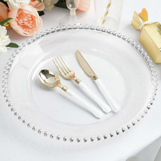 Elegant white plate with gold cutlery on a decorated table.