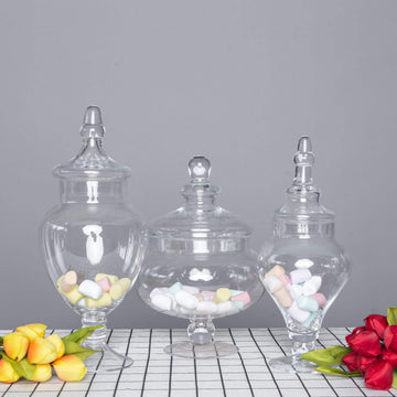 Set of 3 Clear Glass Pedestal Apothecary Party Favor Candy Jars With Snap On Lids - 10" 12" 14"