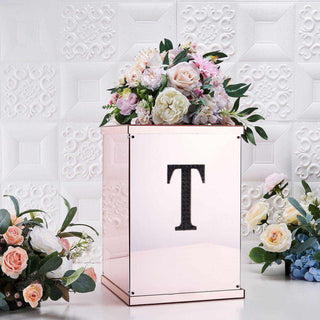 Rose gold floral arrangement box with initial "T" and decorative flowers.